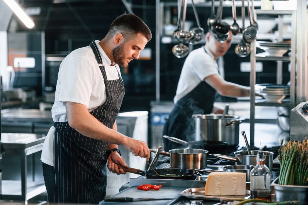 in uniform kitchen workers is together preparing the food