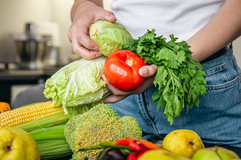 vegetables in female hands the concept of food preparation in the kitchen